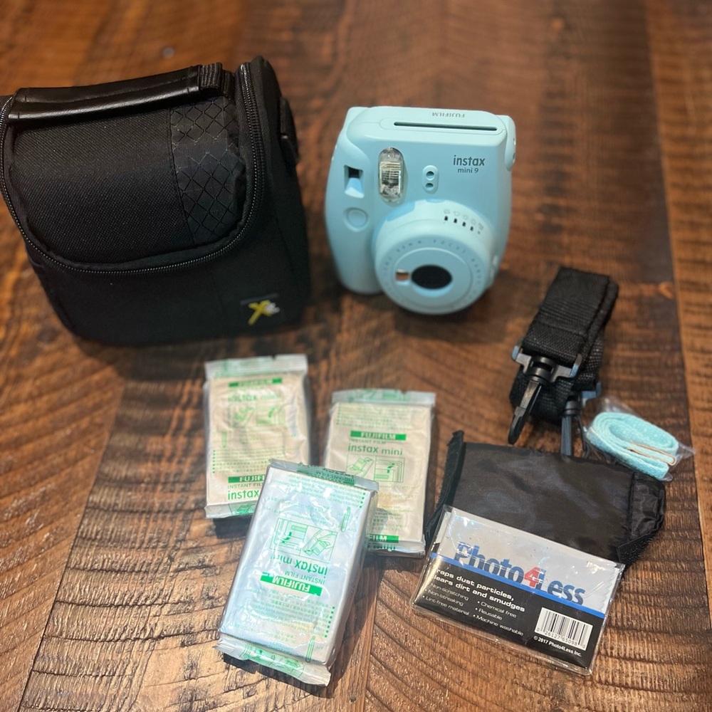 Instax mini 9 camera. Included: film, soft shell case, straps. Light blue.
